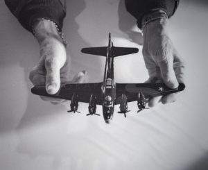 Colonel Morgan holding a replica B-17 bomber in his hands